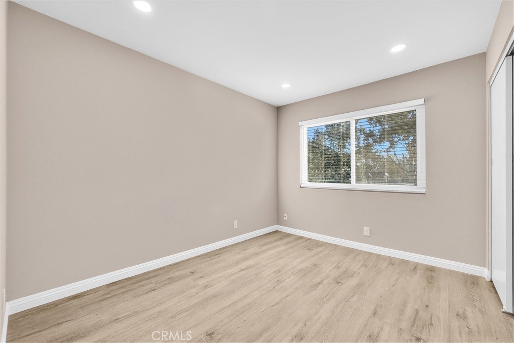 8083 Kerr Green Buena Park, CA 90621 - Photo 20 of 40 an empty room with wooden floor and windows