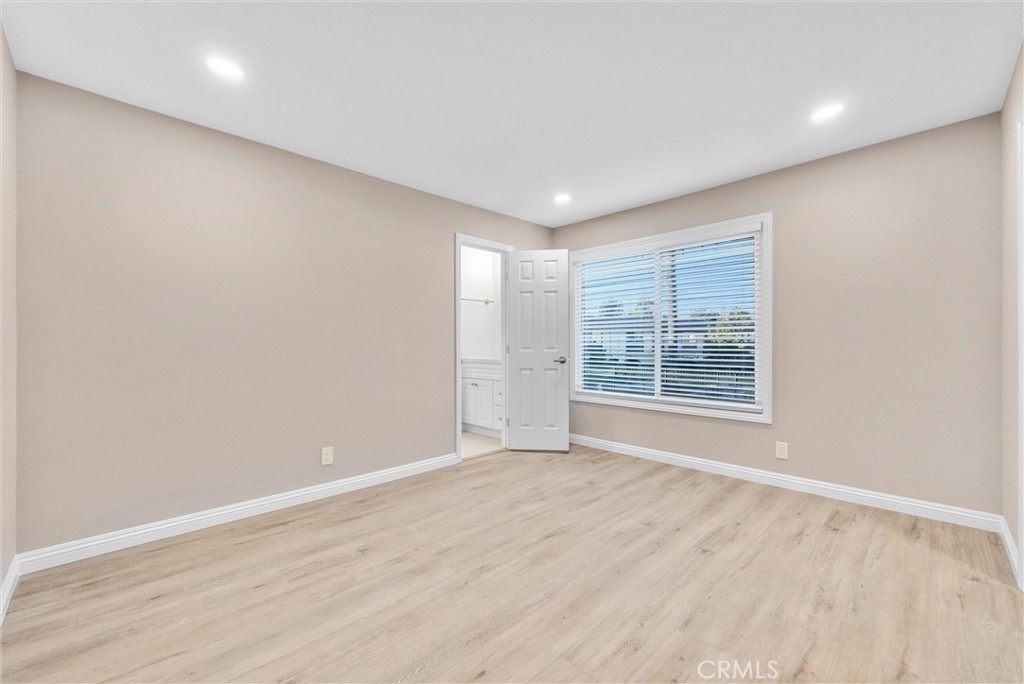 8083 Kerr Green Buena Park, CA 90621 - Photo 22 of 40 a view of an empty room with wooden floor and a window