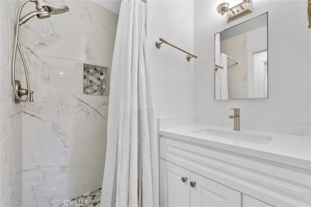 8083 Kerr Green Buena Park, CA 90621 - Photo 24 of 40 a bathroom with a sink a vanity and a shower