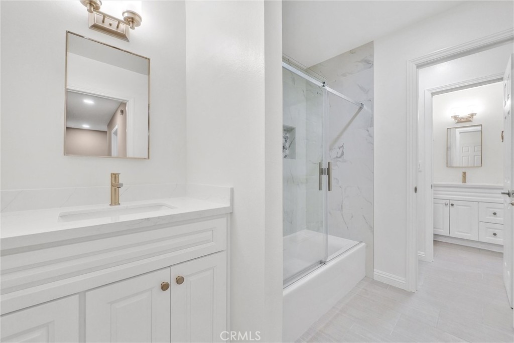 8083 Kerr Green Buena Park, CA 90621 - Photo 26 of 40 a bathroom with a tub shower vanity and a sink