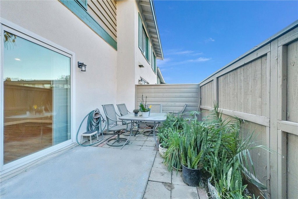 8083 Kerr Green Buena Park, CA 90621 - Photo 30 of 40 a view of a patio with table and chairs and potted plants with wooden floor