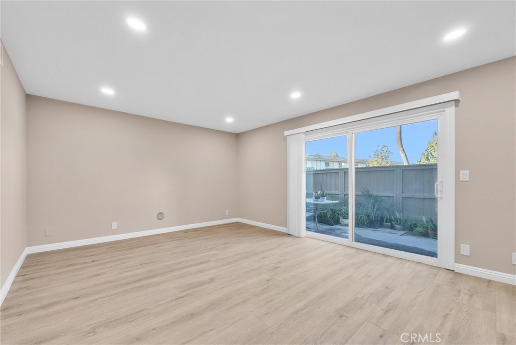 8083 Kerr Green Buena Park, CA 90621 - Photo 7 of 40 a view of an empty room with wooden floor and a window