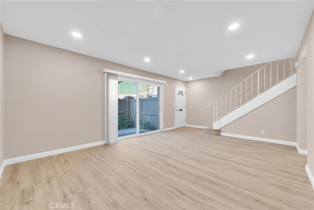8083 Kerr Green Buena Park, CA 90621 - Photo 8 of 40 a view of an empty room with wooden floor and a window