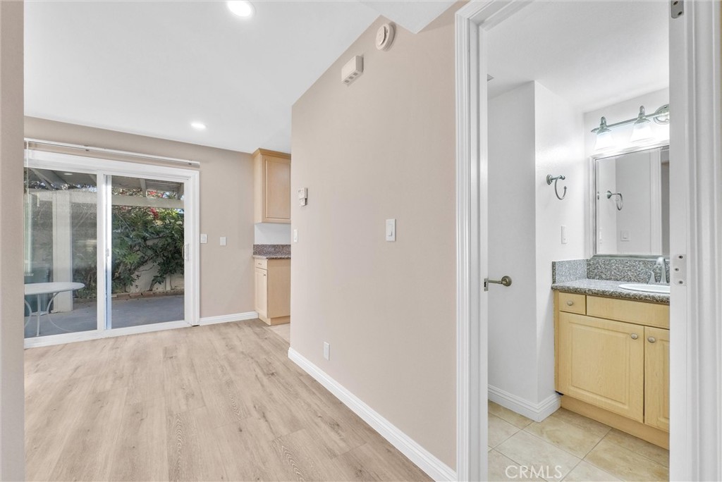8083 Kerr Green Buena Park, CA 90621 - Photo 10 of 40 a view of a hallway with bathroom and wooden floor