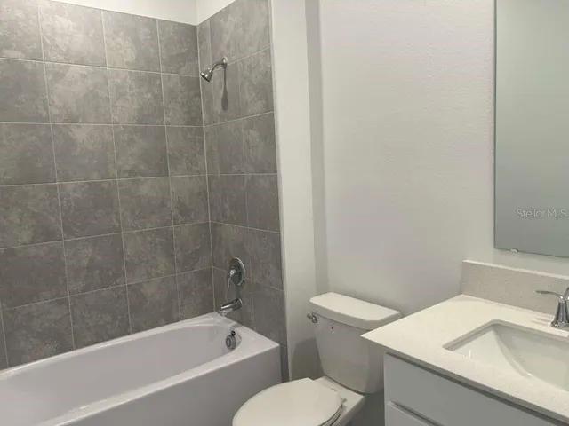 a white bath tub sitting next to a white toilet