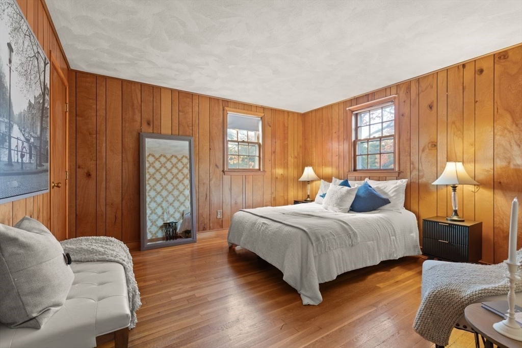 7 Debra Lane Framingham, MA 01701 - Photo 15 of 27 a bedroom with a bed and wooden floor