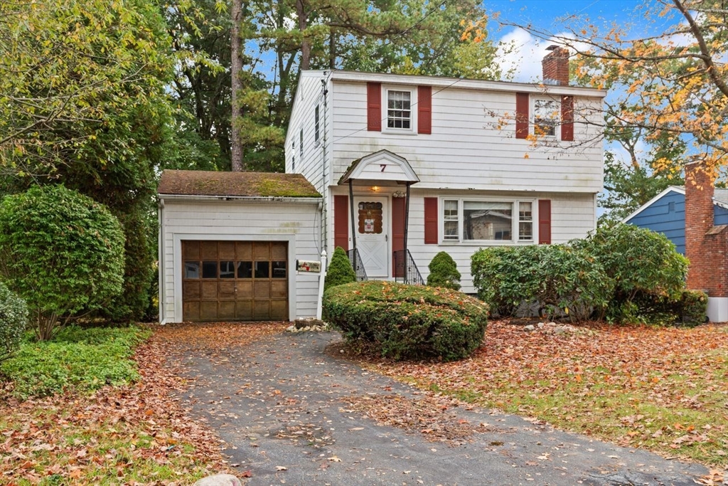 7 Debra Lane Framingham, MA 01701 - Photo 2 of 27 a front view of a house with a yard and garage