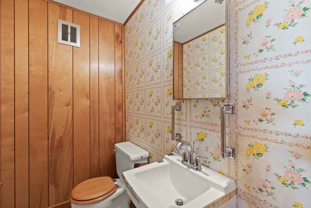 7 Debra Lane Framingham, MA 01701 - Photo 21 of 27 a bathroom with a sink a toilet and shower curtain