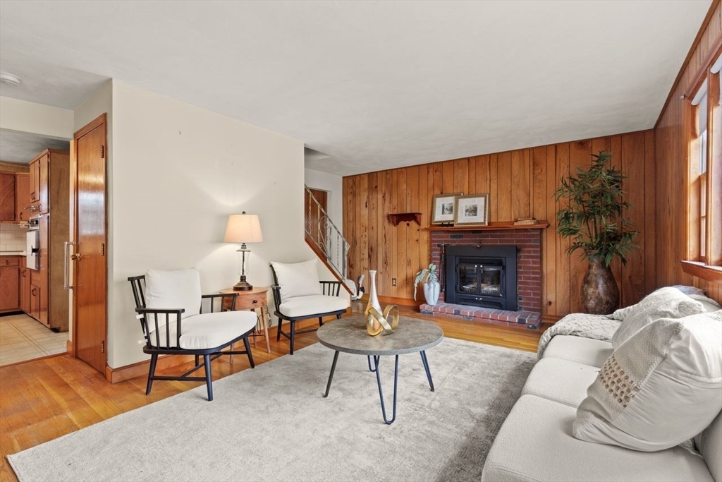 7 Debra Lane Framingham, MA 01701 - Photo 4 of 27 a living room with furniture a fireplace and a large window