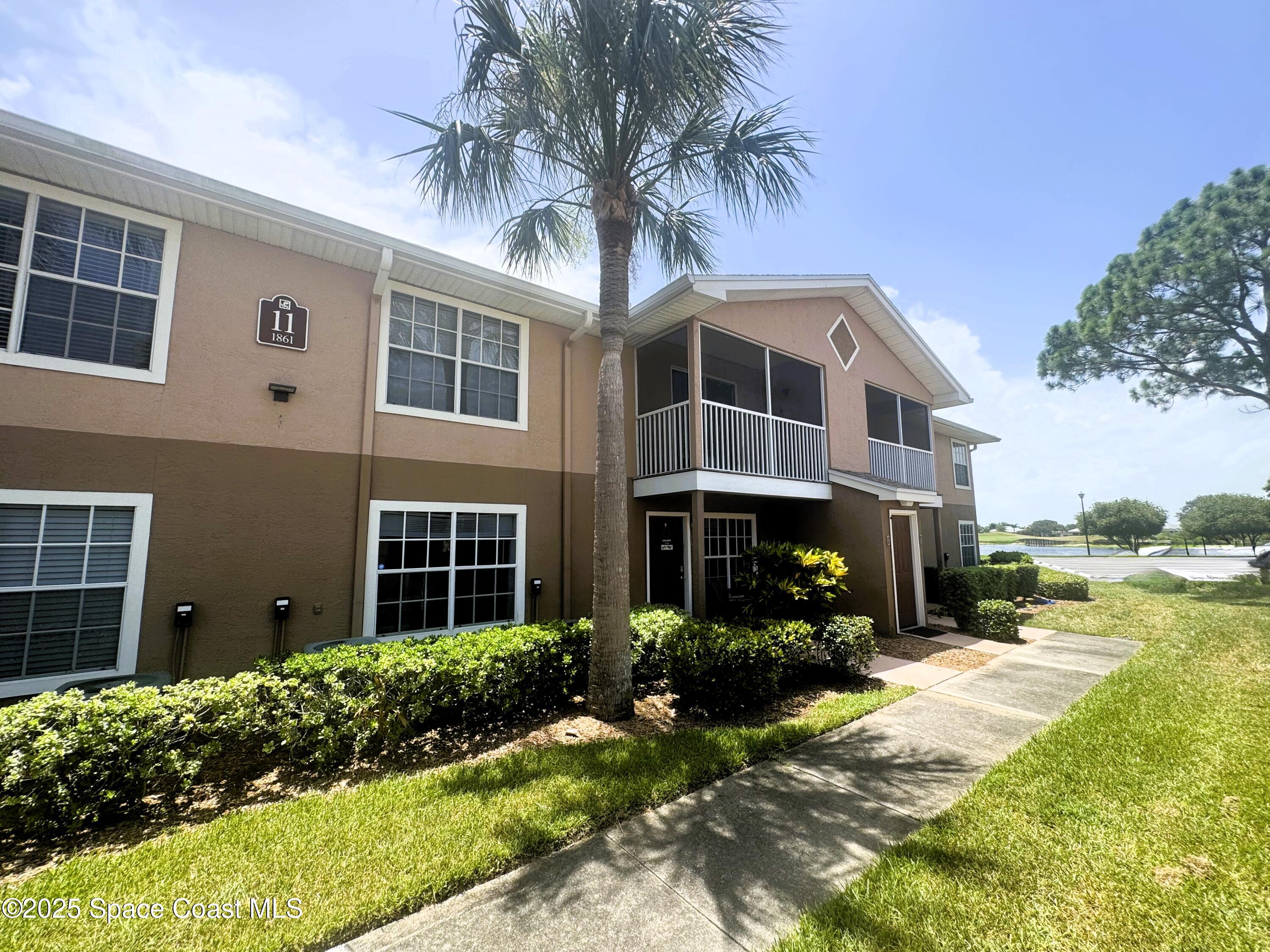 1861 Long Iron Drive, Unit 1121 Rockledge, FL 32955 - Photo 1 of 35 a front view of a house with a yard