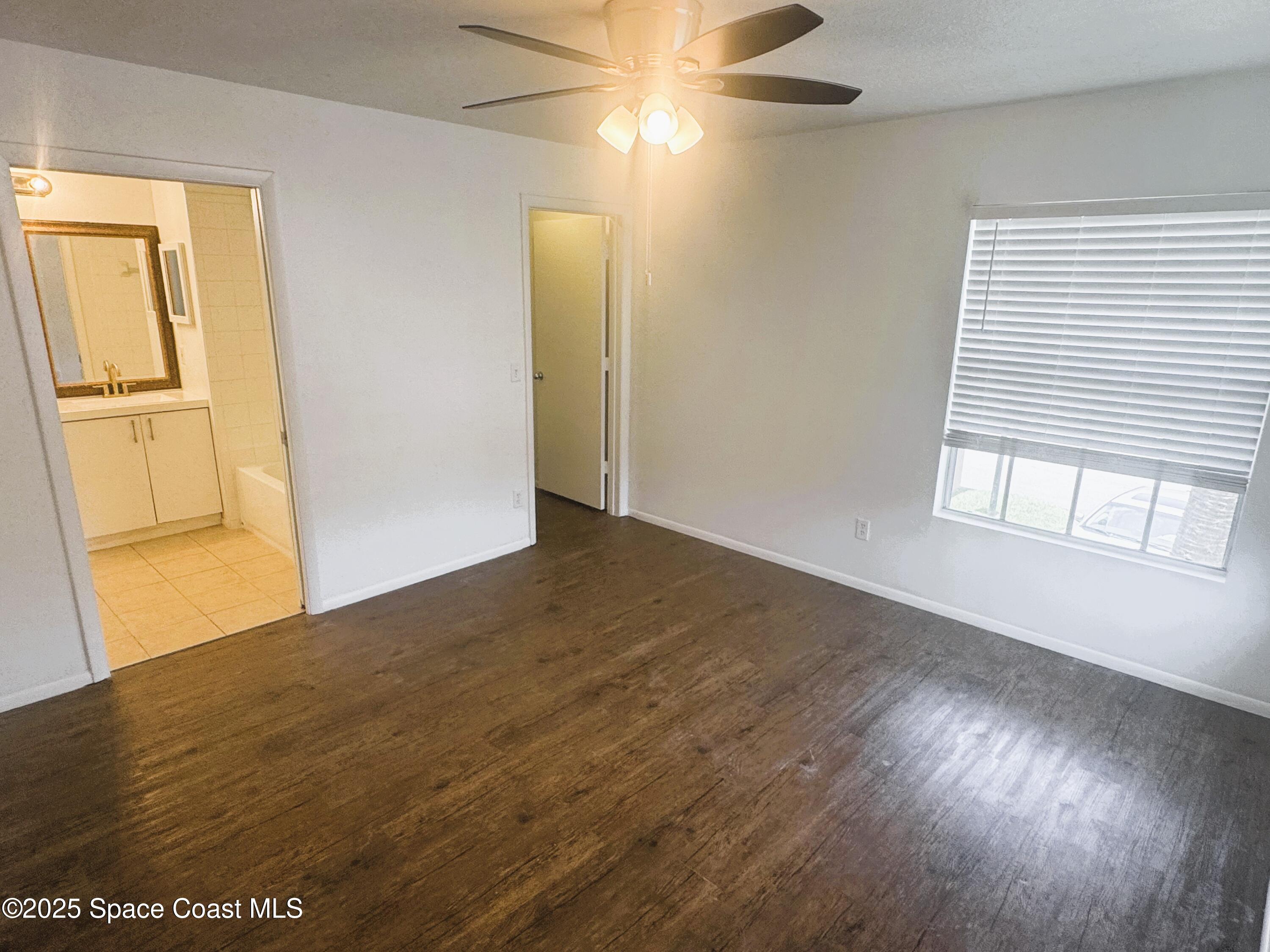 1861 Long Iron Drive, Unit 1121 Rockledge, FL 32955 - Photo 12 of 35 a view of empty room with wooden floor and fan