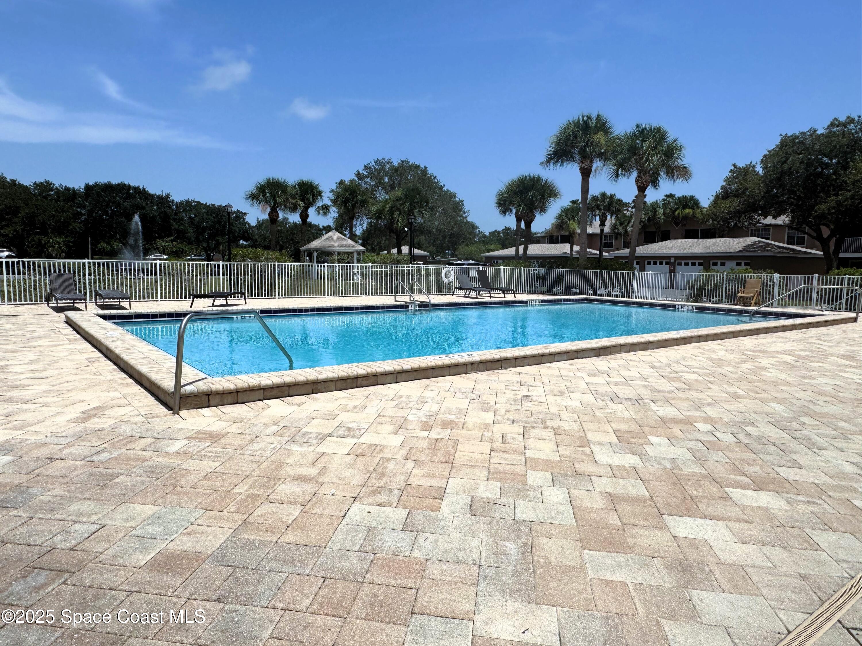 1861 Long Iron Drive, Unit 1121 Rockledge, FL 32955 - Photo 24 of 35 a view of a swimming pool with a lounge chair