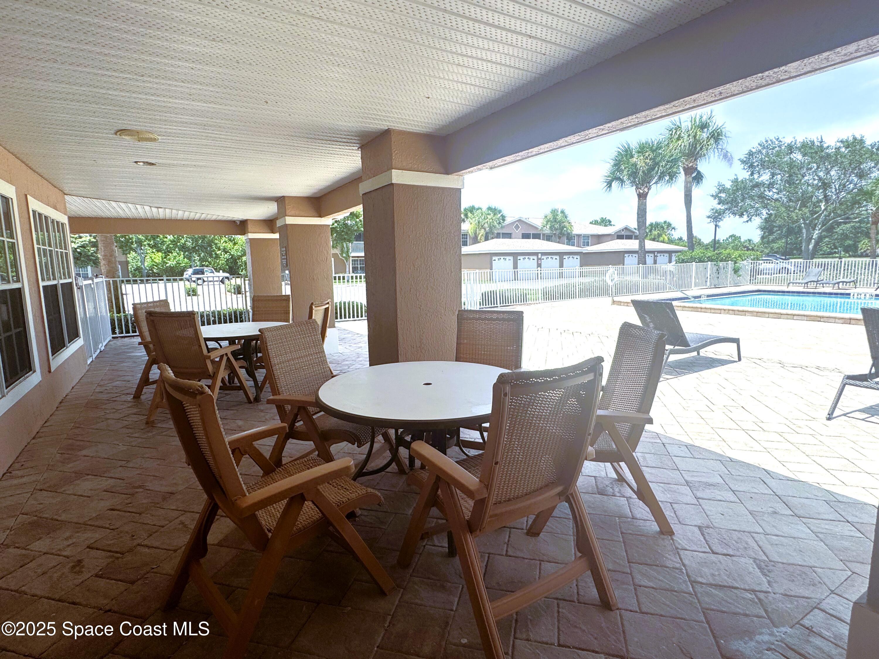 1861 Long Iron Drive, Unit 1121 Rockledge, FL 32955 - Photo 26 of 35 a view of a dining room with furniture large windows and wooden floor