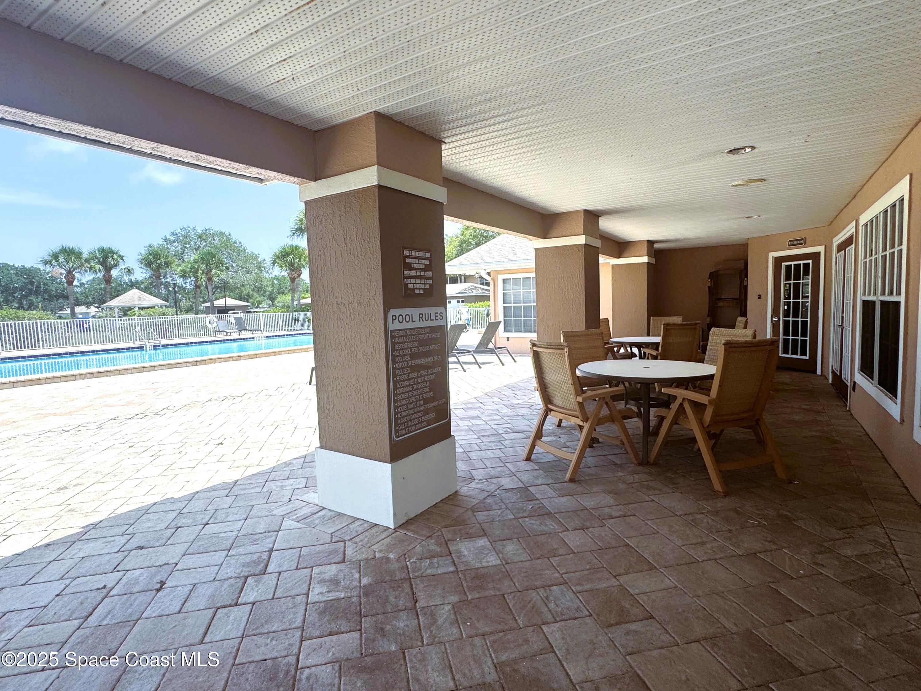 1861 Long Iron Drive, Unit 1121 Rockledge, FL 32955 - Photo 27 of 35 a view of a patio with a table and chairs in patio
