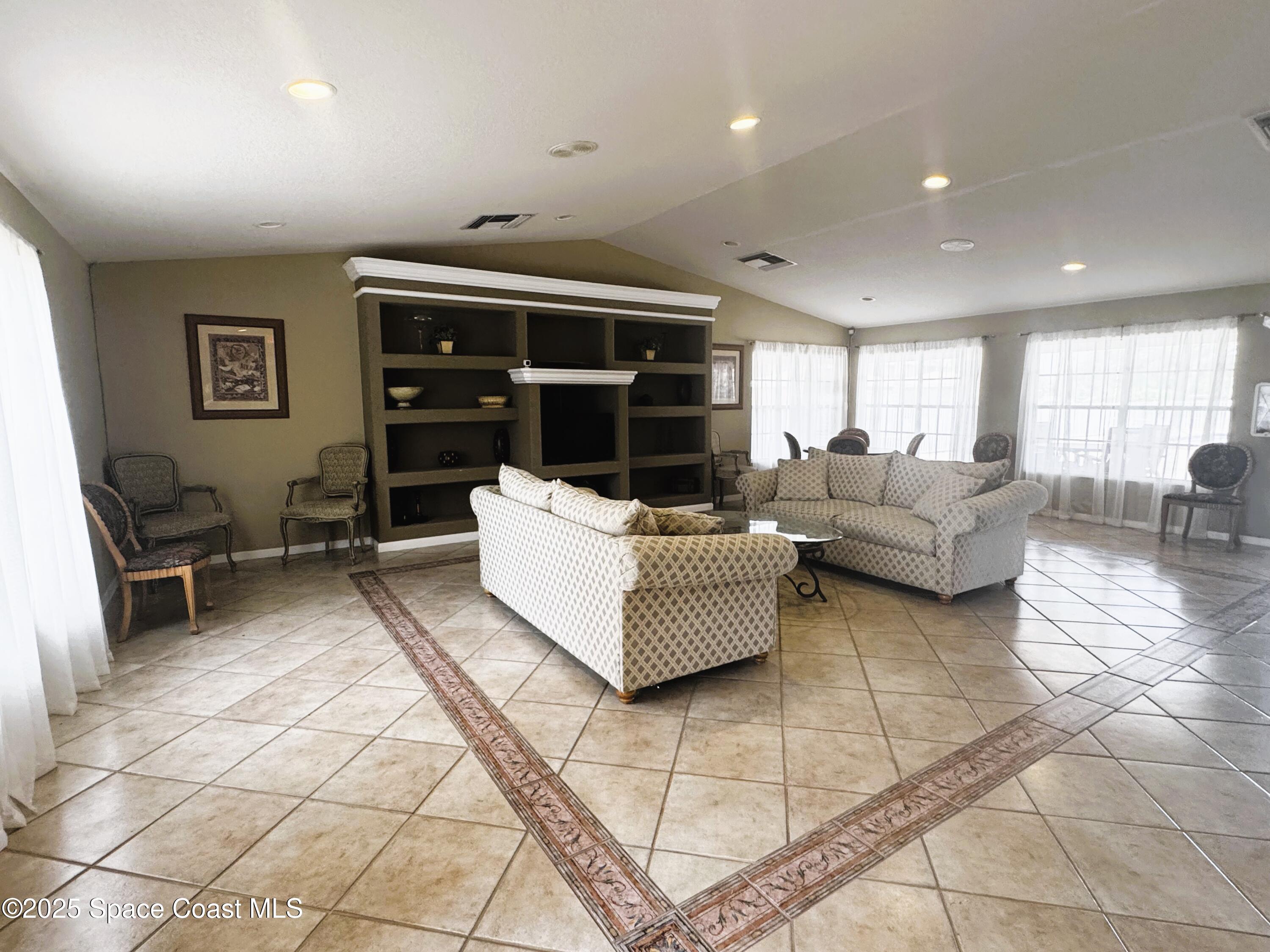 1861 Long Iron Drive, Unit 1121 Rockledge, FL 32955 - Photo 30 of 35 a living room with furniture and a rug