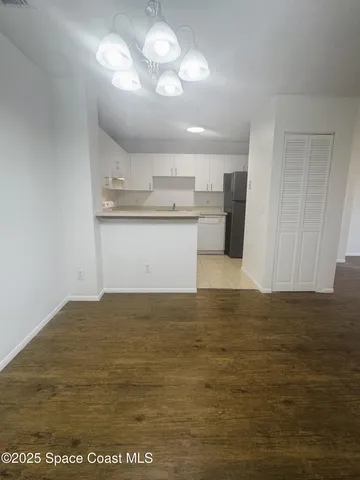 a kitchen with granite countertop a stove a sink and a refrigerator