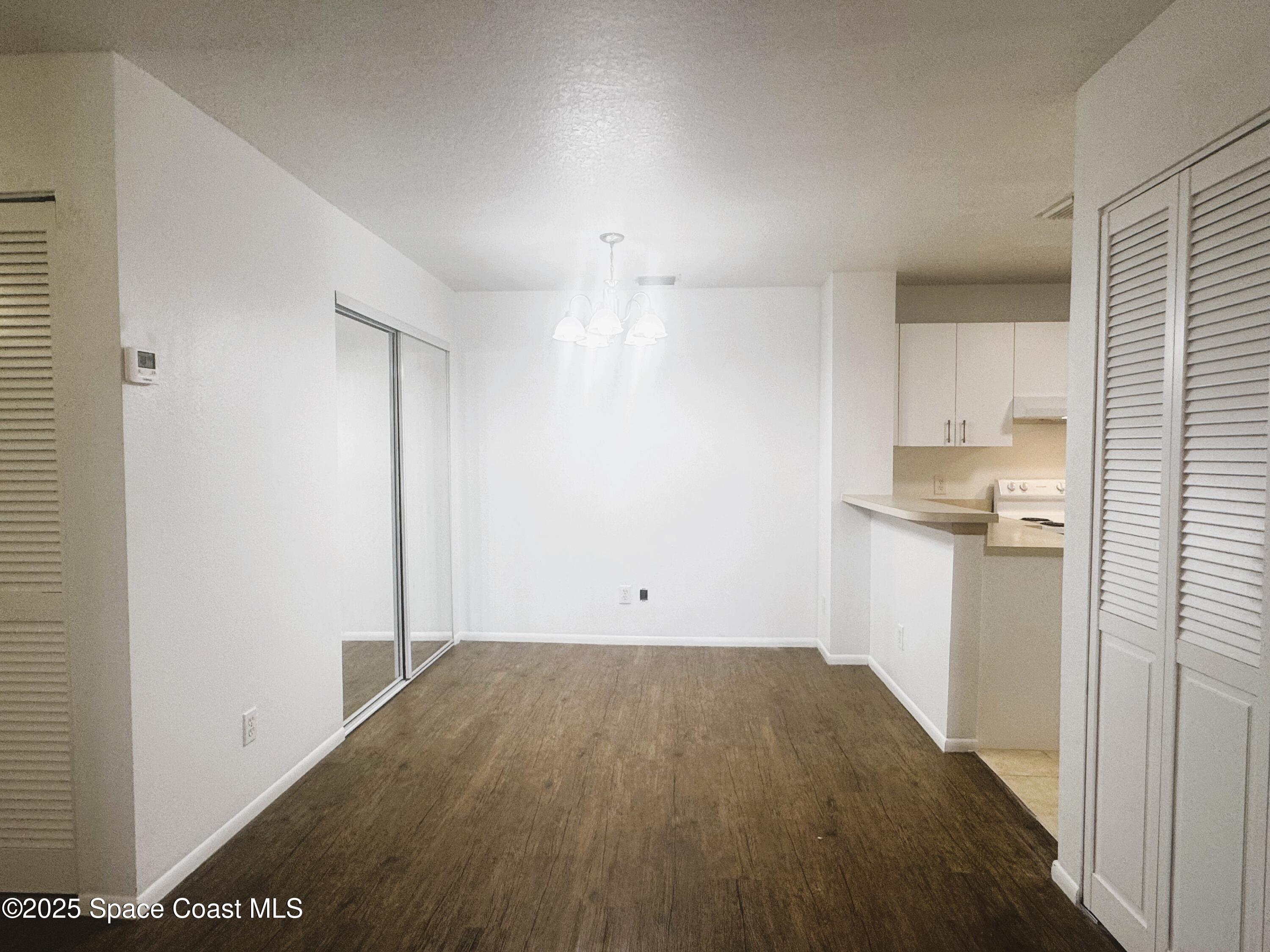 1861 Long Iron Drive, Unit 1121 Rockledge, FL 32955 - Photo 7 of 35 a view of empty room with wooden floor