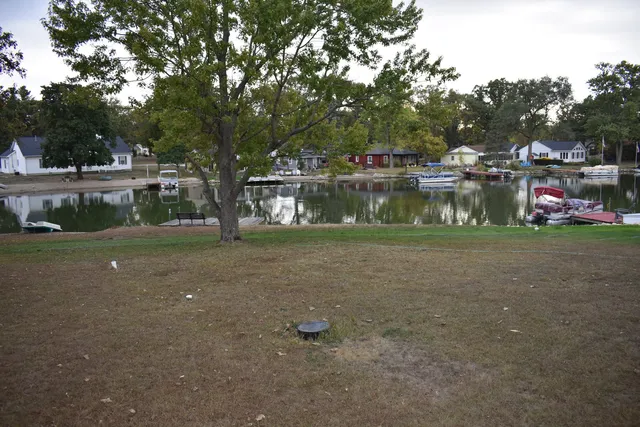 a view of balcony with wooden floor and lake view
