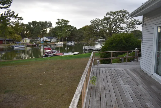 a view of a lake with boats and trees in the background