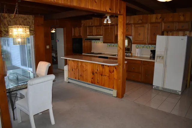 a kitchen with a refrigerator and a table