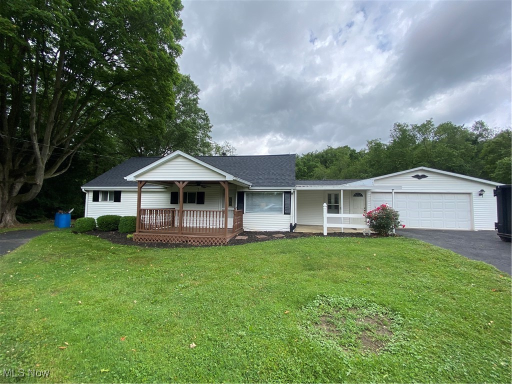 14092 Hatfield Road Rittman, OH 44270 - Photo 2 of 38 Single story home with covered porch, driveway, a front lawn, a shingled roof, and a garage