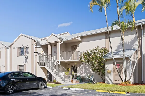 a car parked in front of white house