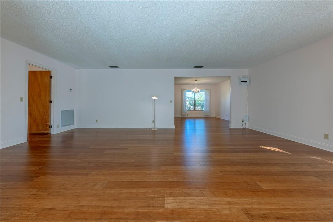 12500 Lake Road Davie, FL 33325 - Photo 11 of 34 wooden floor in an empty room with a window