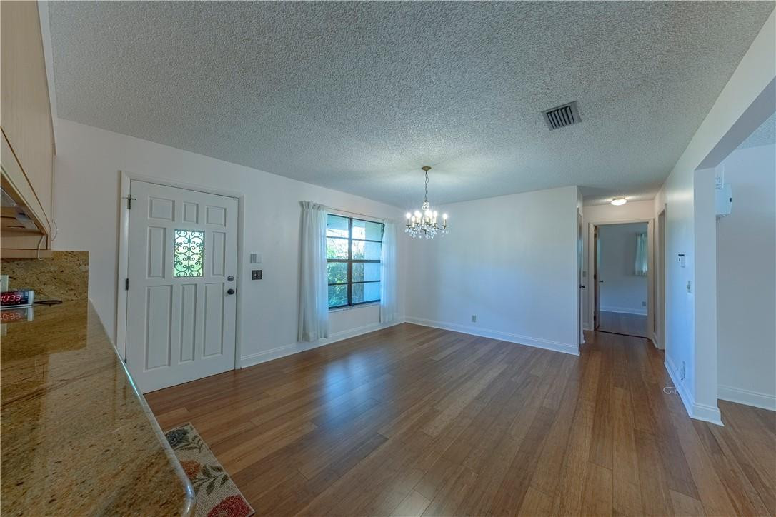 12500 Lake Road Davie, FL 33325 - Photo 16 of 34 an empty room with wooden floor and mirror