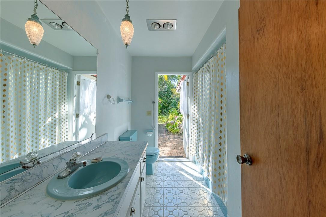 12500 Lake Road Davie, FL 33325 - Photo 19 of 34 a bathroom with a sink a mirror a window and a shower