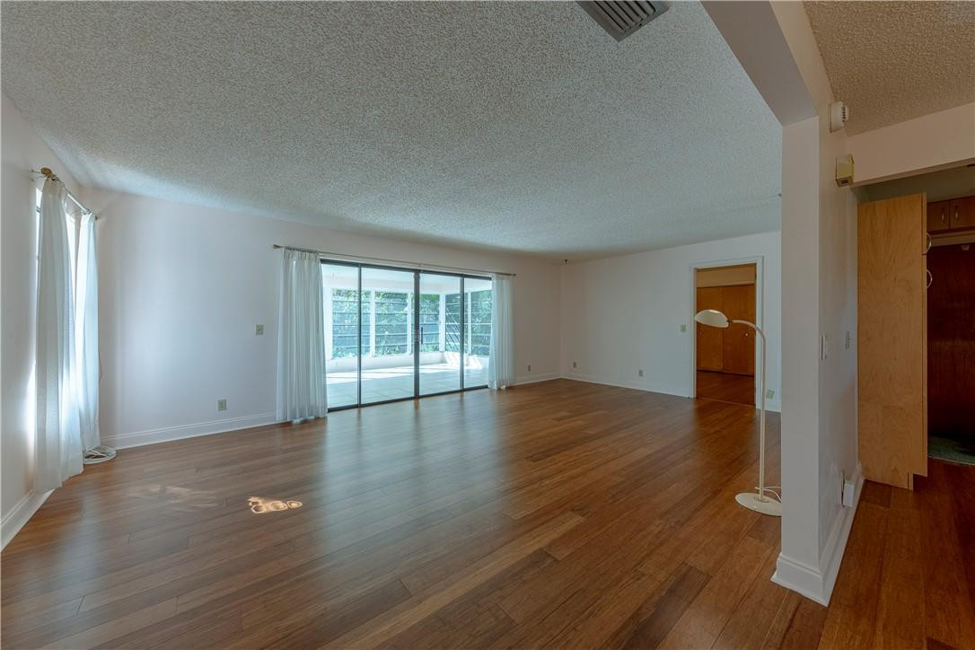 12500 Lake Road Davie, FL 33325 - Photo 3 of 34 an empty room with wooden floor and windows