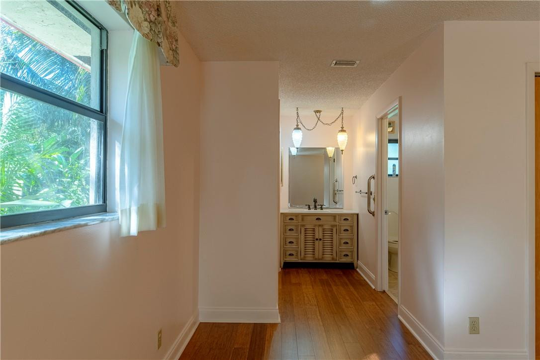 12500 Lake Road Davie, FL 33325 - Photo 8 of 34 a view of a hallway with entryway door with wooden floor