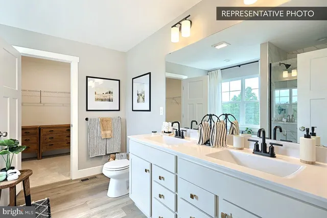 a bathroom with double sink and a mirror