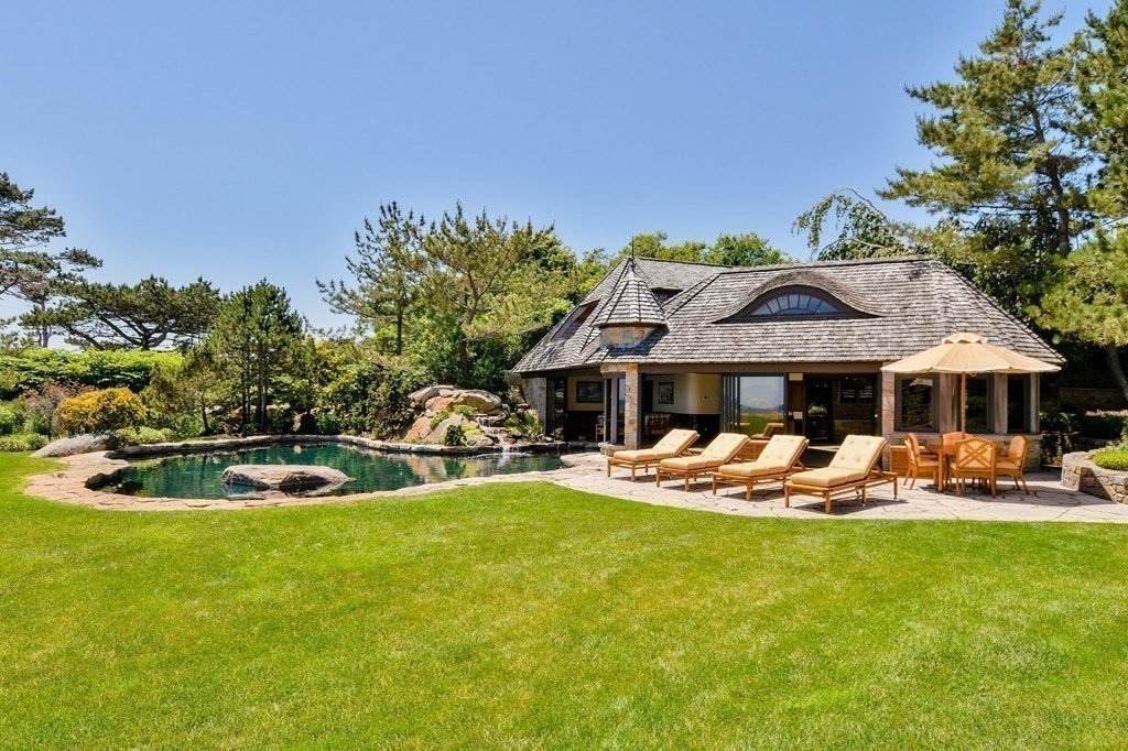 9 Drumhack Road Gloucester, MA 01930 - Photo 16 of 28 a view of a swimming pool with lawn chairs under an umbrella