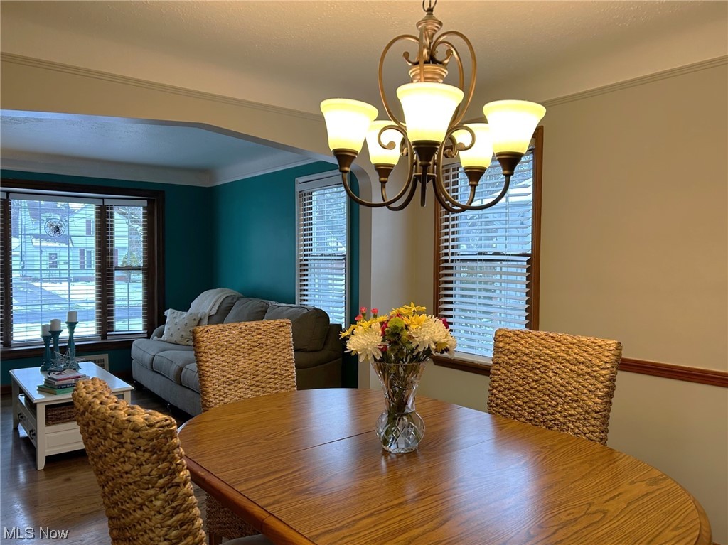 1748 Sunview Road Lyndhurst, OH 44124 - Photo 17 of 41 Dining room featuring an inviting chandelier and chair railing.