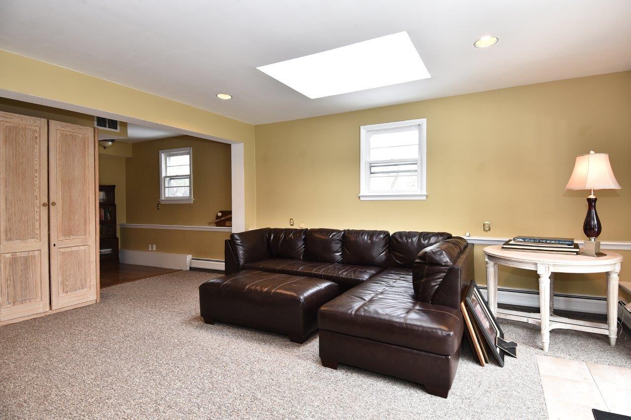 17 Field Crest Road New Canaan, CT 06840 - Photo 21 of 37 a living room with a couch and a view of kitchen