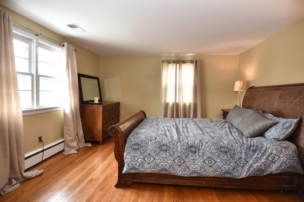 17 Field Crest Road New Canaan, CT 06840 - Photo 31 of 37 a bedroom with a bed and wooden floor