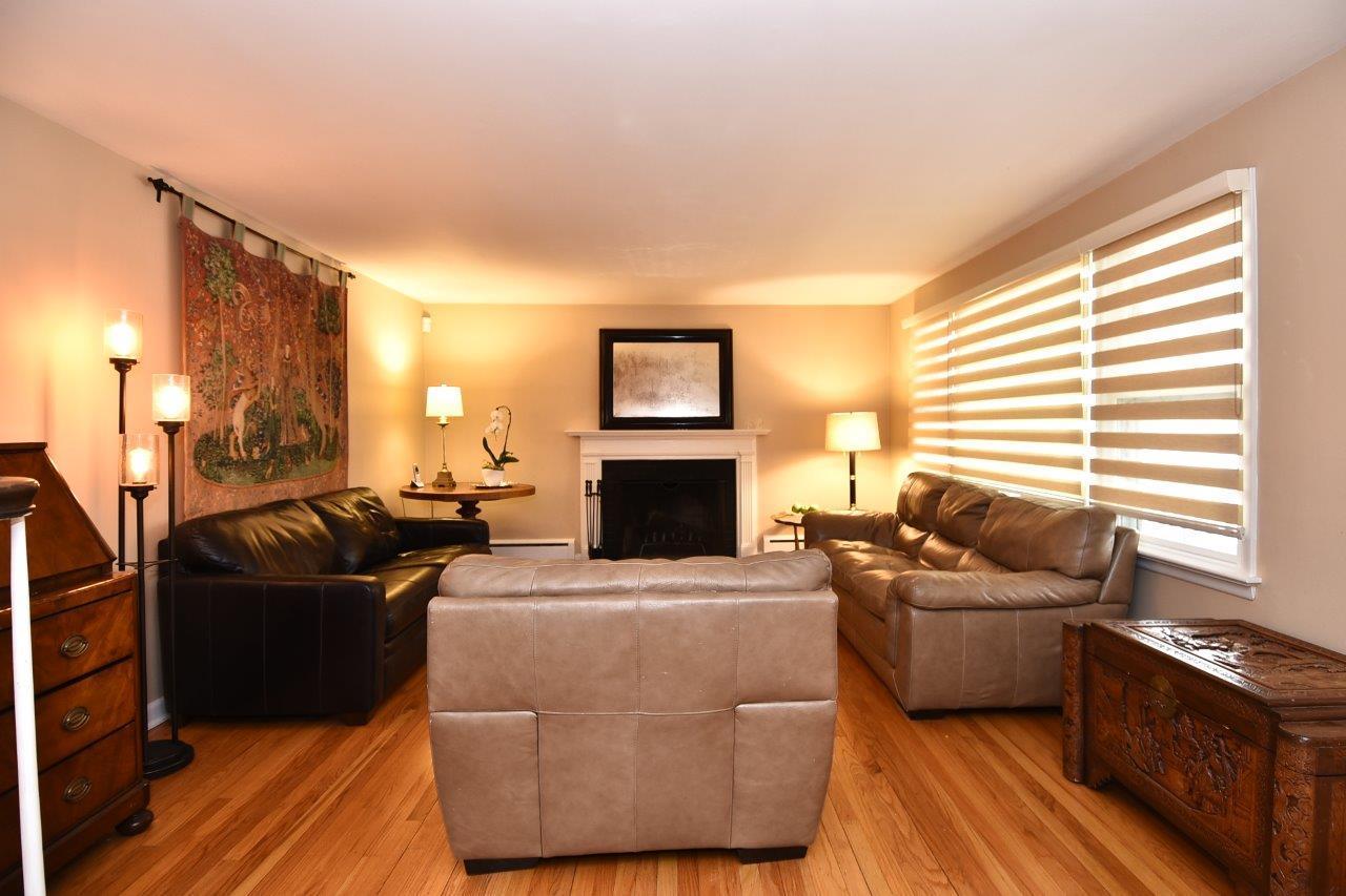 17 Field Crest Road New Canaan, CT 06840 - Photo 6 of 37 a living room with furniture a fireplace and a flat screen tv