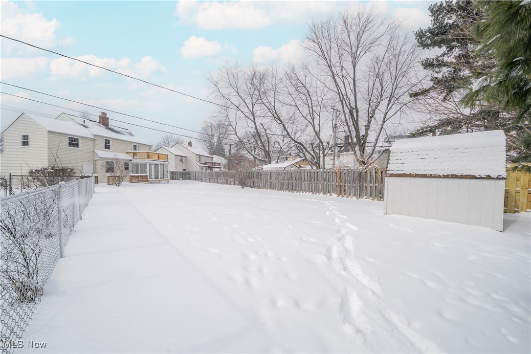 2279 North Taylor Road Cleveland, OH 44112 - Photo 33 of 35 Yard covered in snow with a fence and shed