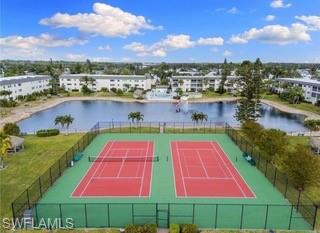 1018 Manatee Road, Unit E107 Naples, FL 34114 - Photo 13 of 15 View of tennis court with a water view
