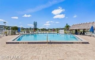 1018 Manatee Road, Unit E107 Naples, FL 34114 - Photo 14 of 15 Community pool featuring a patio area and a pergola