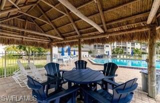 1018 Manatee Road, Unit E107 Naples, FL 34114 - Photo 15 of 15 View of patio with a community pool and outdoor dining space