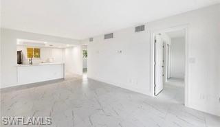 1018 Manatee Road, Unit E107 Naples, FL 34114 - Photo 5 of 15 Unfurnished living room with light marble finish flooring