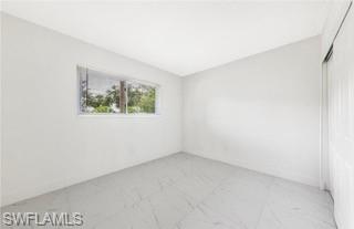 1018 Manatee Road, Unit E107 Naples, FL 34114 - Photo 8 of 15 Spare room featuring baseboards