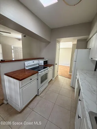a kitchen with granite countertop a stove and a sink