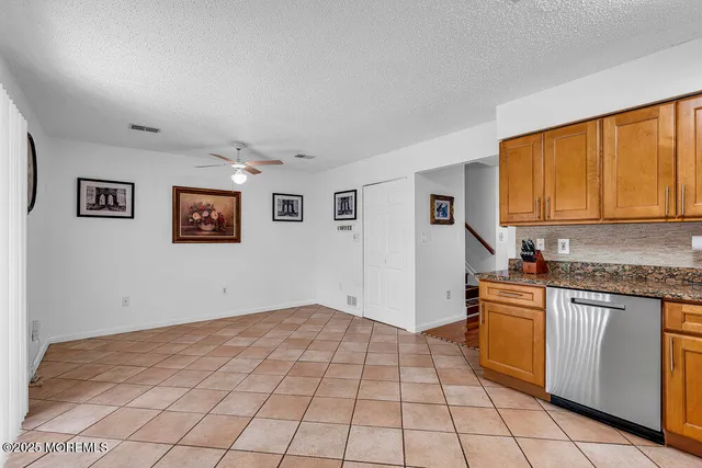 a kitchen with stainless steel appliances granite countertop a refrigerator and a stove