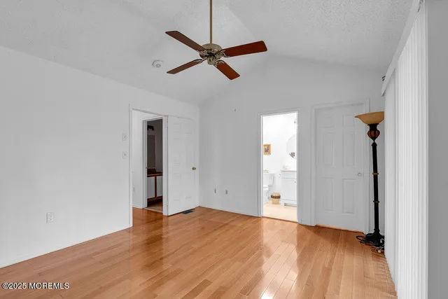 a view of a room with wooden floor and white walls