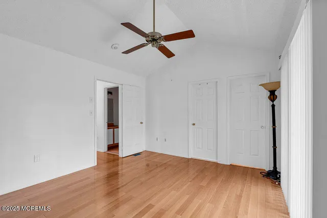 a view of a room with wooden floor and white walls