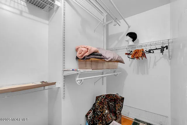 a view of storage and utility room with racks on the wall