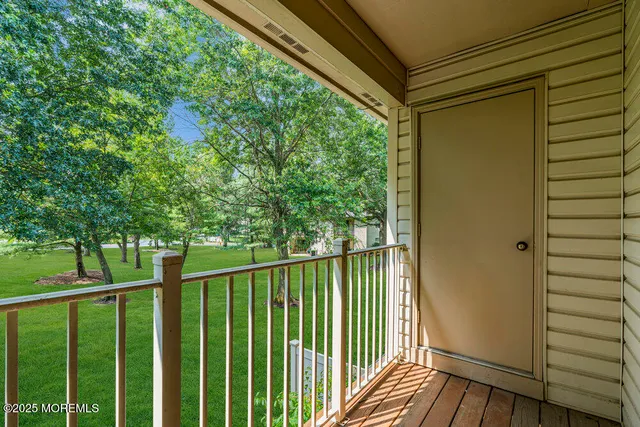 a view of a balcony with wooden floor