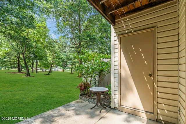 a view of a chair and table in the garden